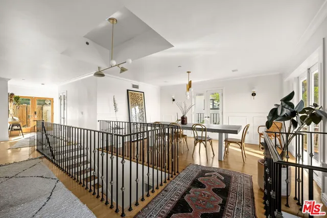 a view of a hallway with dining room and furniture