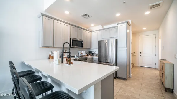 a kitchen with a refrigerator a sink and a stove