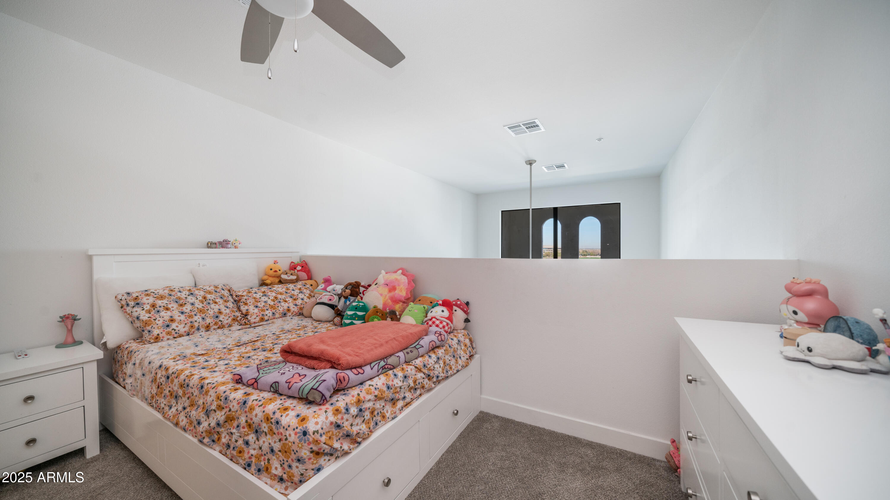 2511 West Queen Creek Road, Unit 479 Chandler, AZ 85248 - Photo 12 of 68 a bedroom with a bed and a chandelier