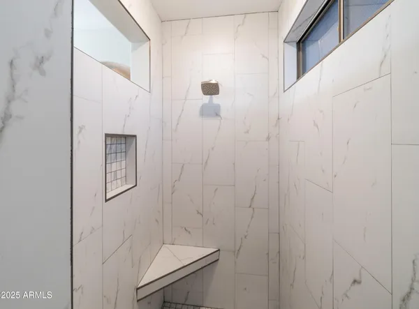 an aerial view of residential houses with outdoor space and ocean view