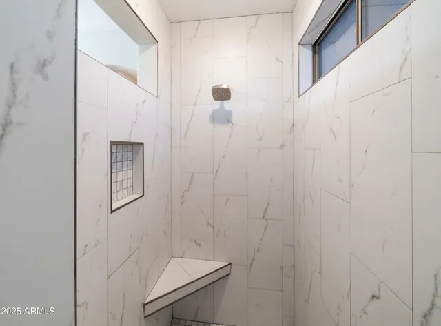 an aerial view of residential houses with outdoor space and ocean view