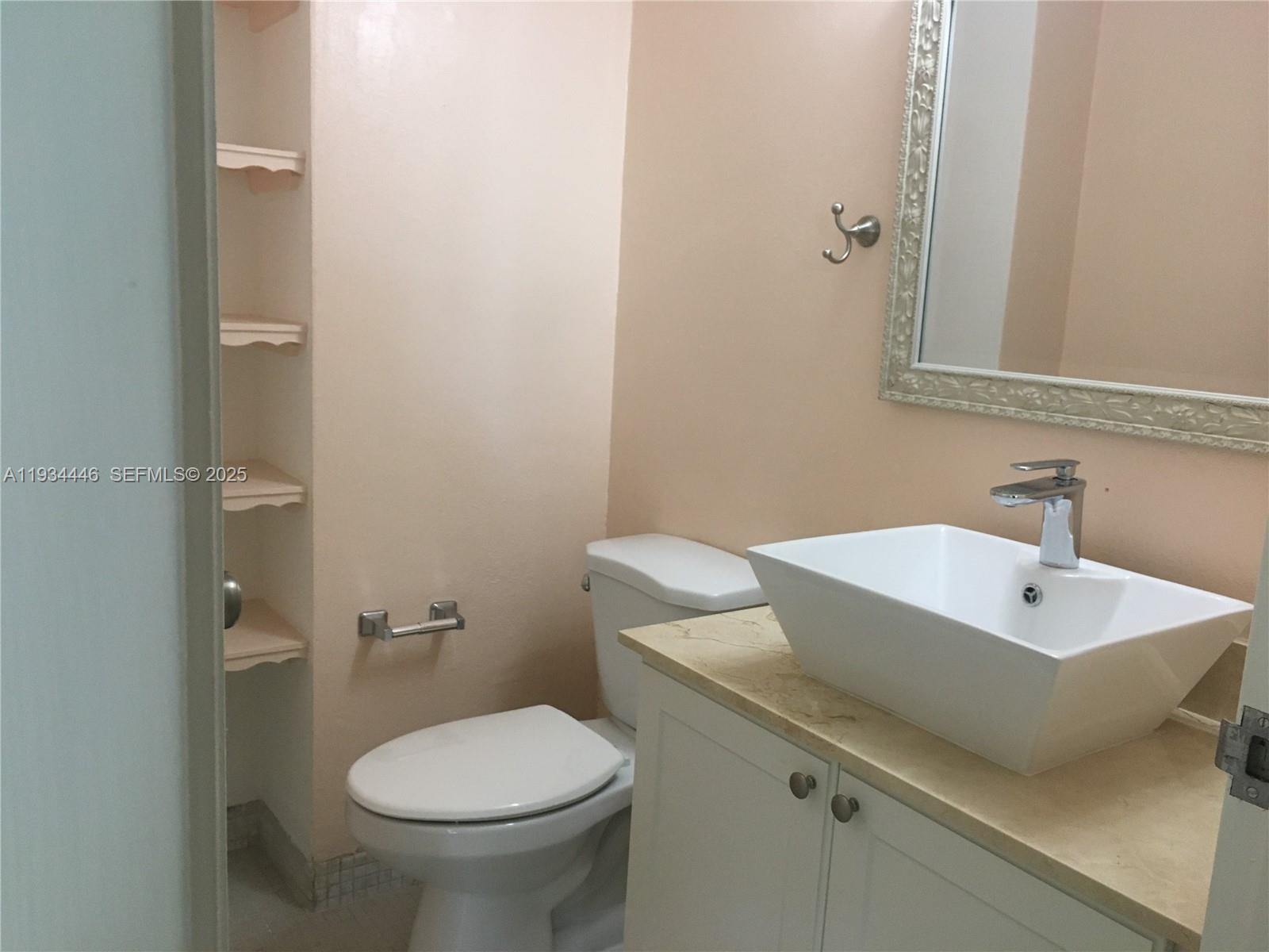 9225 Collins Avenue, Unit 305 Surfside, FL 33154 - Photo 3 of 10 a bathroom with a sink and a toilet