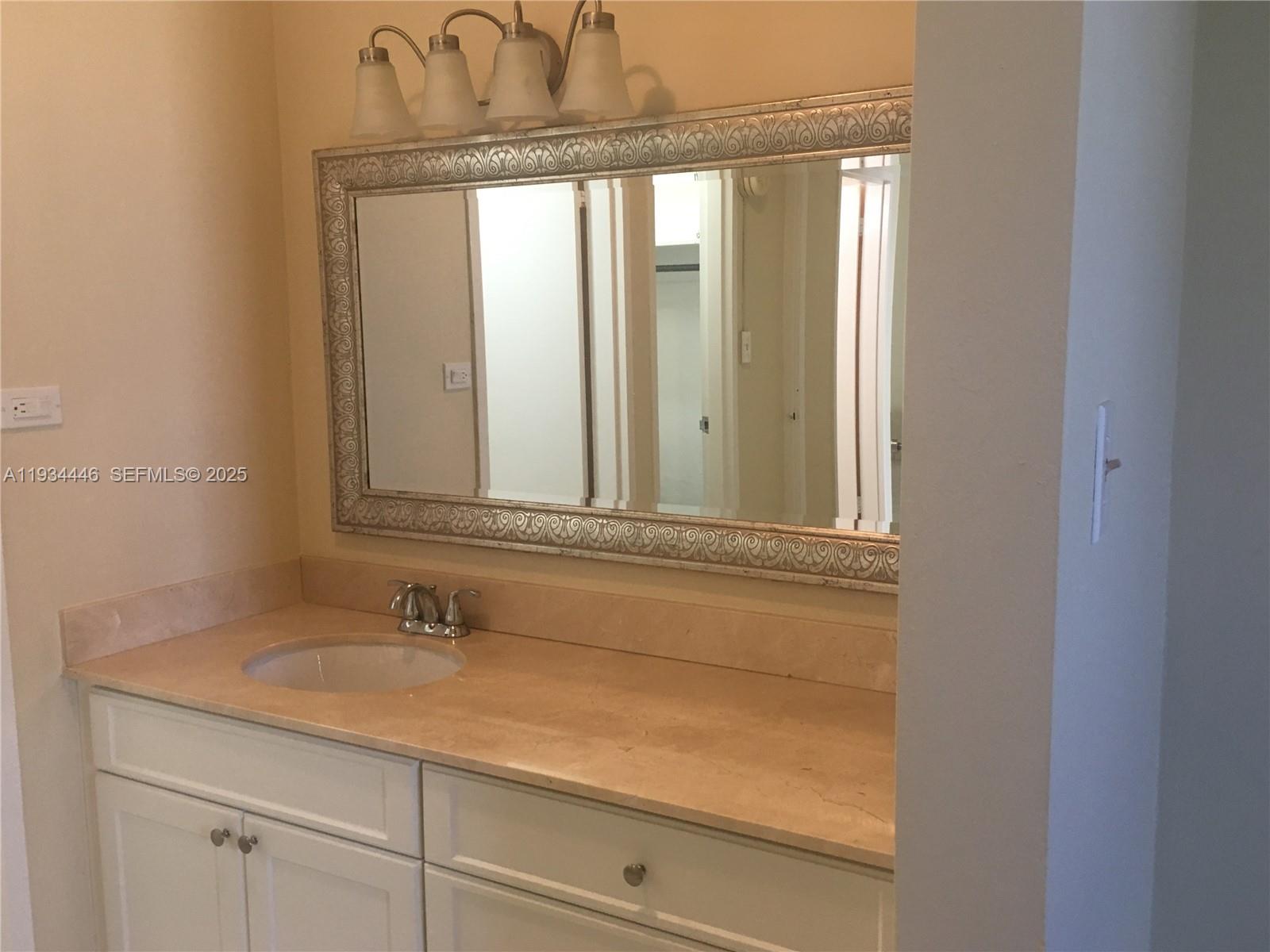 9225 Collins Avenue, Unit 305 Surfside, FL 33154 - Photo 4 of 10 a bathroom with a sink and a mirror