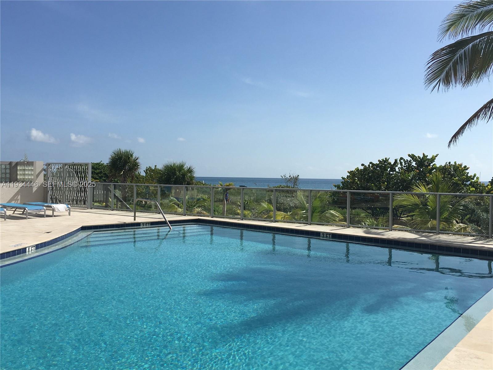 9225 Collins Avenue, Unit 305 Surfside, FL 33154 - Photo 10 of 10 a view of outdoor space with swimming pool and seating