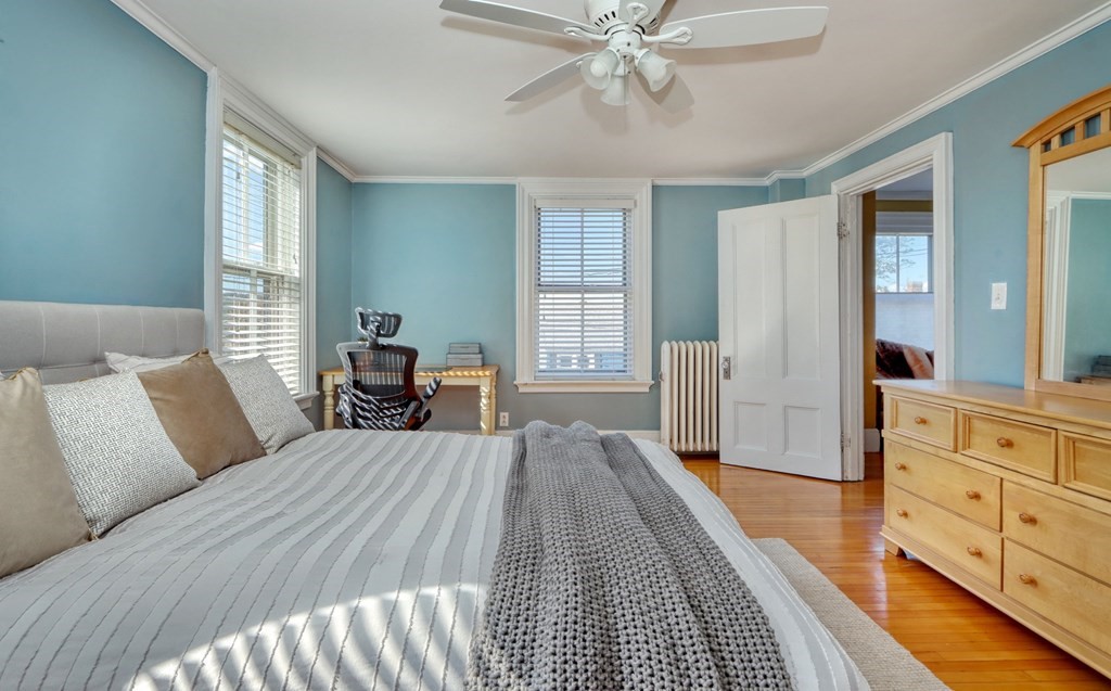 5 Chestnut Street Melrose, MA 02176 - Photo 23 of 42 a bedroom with a bed and wooden floor