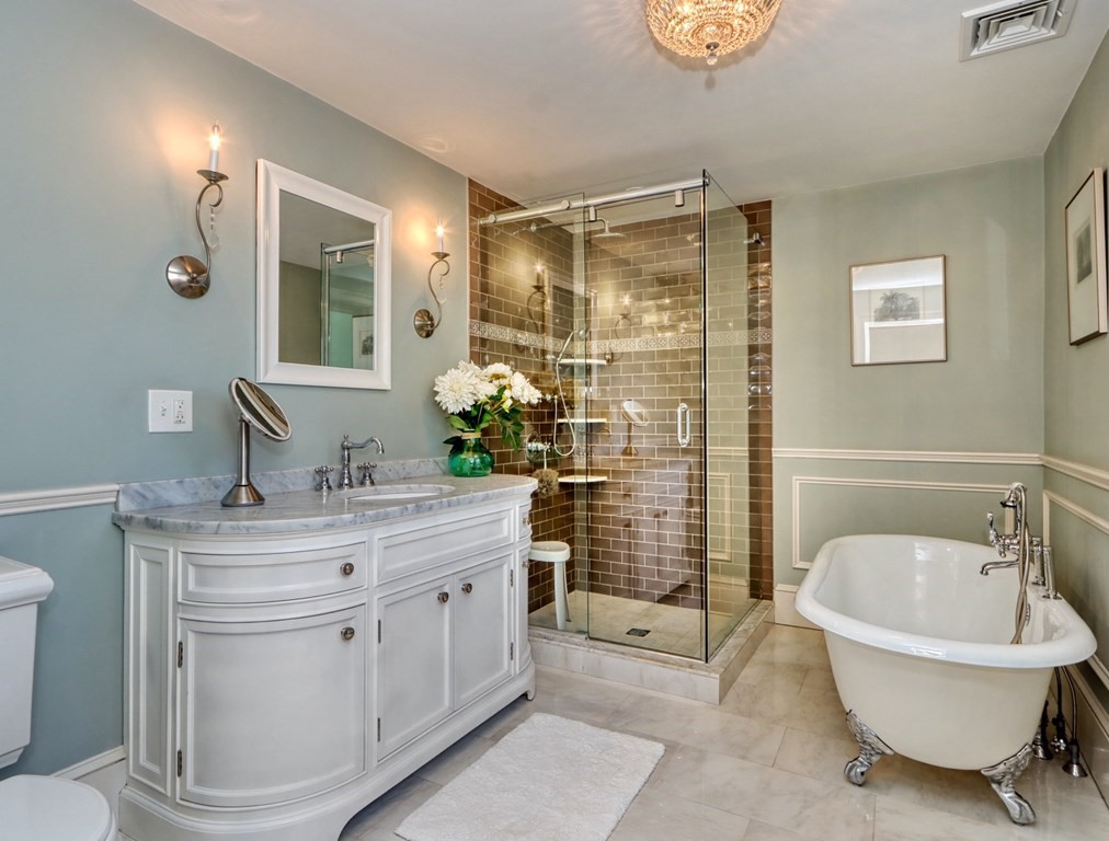 5 Chestnut Street Melrose, MA 02176 - Photo 29 of 42 a bathroom with a tub sink and mirror