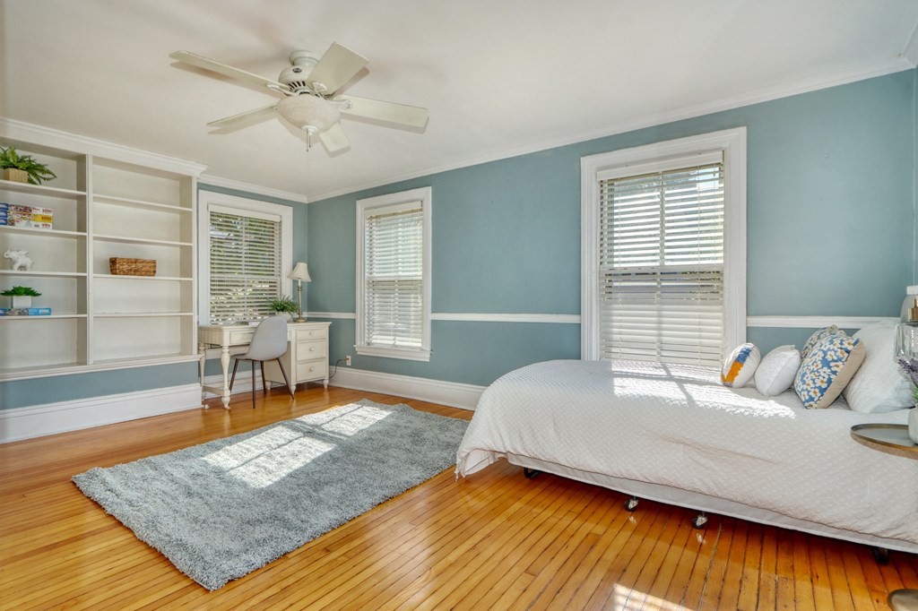 5 Chestnut Street Melrose, MA 02176 - Photo 30 of 42 a bedroom with a bed a table and chair