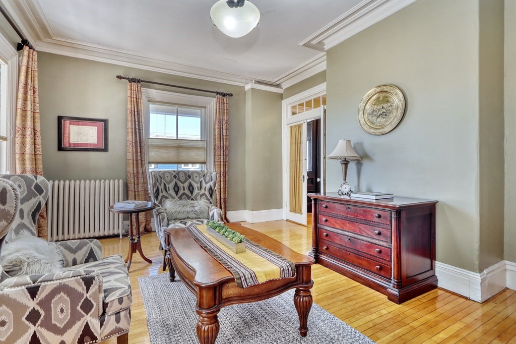 5 Chestnut Street Melrose, MA 02176 - Photo 6 of 42 a living room with furniture a clock on wall and a window