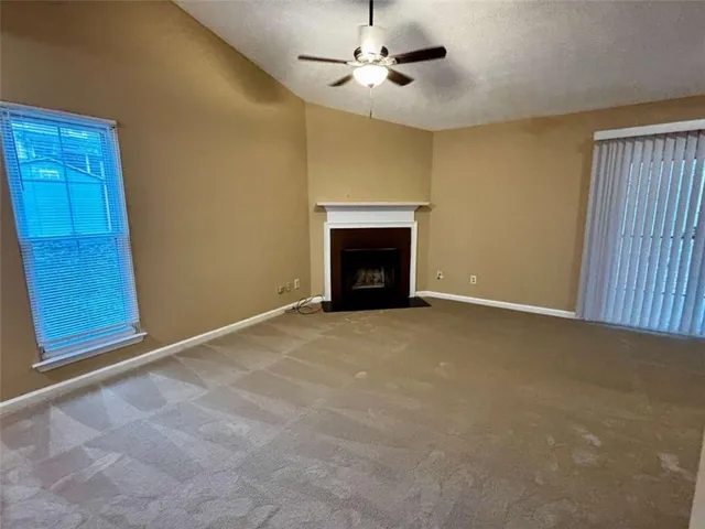 a view of an empty room with a fireplace