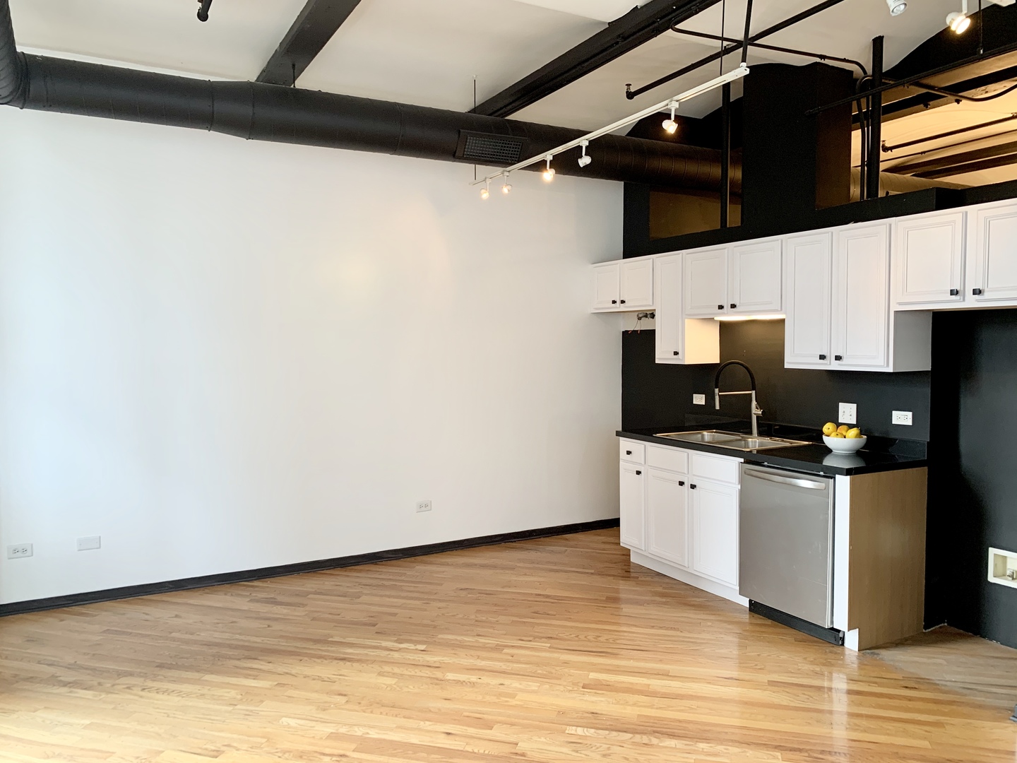 500 South Clinton Street, Unit 417 Chicago, IL 60607 - Photo 5 of 18 a kitchen with stainless steel appliances a white cabinet and a microwave