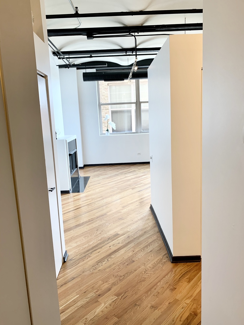 500 South Clinton Street, Unit 417 Chicago, IL 60607 - Photo 8 of 18 a view of a room with wooden floor and a window