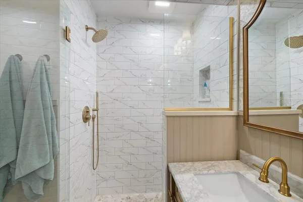 a view of a swimming pool with lounge chairs under an umbrella