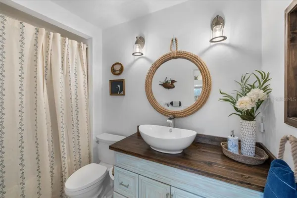 a view of a balcony with chairs and wooden fence