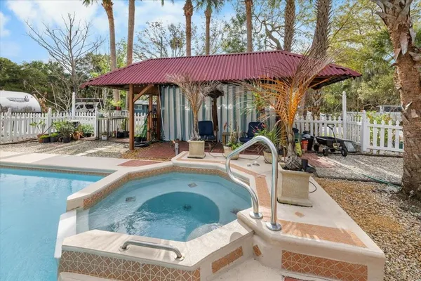 a view of a chairs and table in backyard