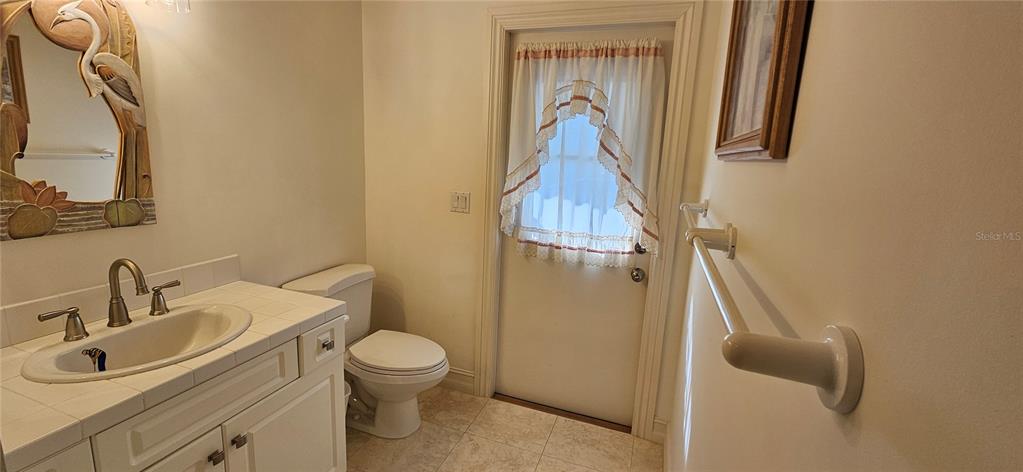 11729 Timberline Circle Fort Myers, FL 33966 - Photo 12 of 33 a bathroom with a toilet sink and mirror