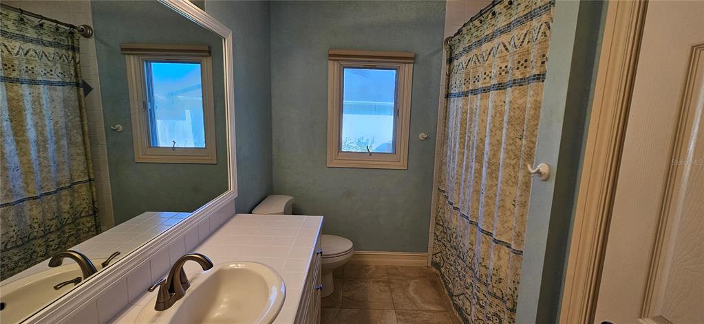 11729 Timberline Circle Fort Myers, FL 33966 - Photo 15 of 33 a bathroom with a sink and a mirror