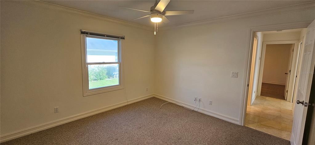 11729 Timberline Circle Fort Myers, FL 33966 - Photo 16 of 33 an empty room with a window and closet area