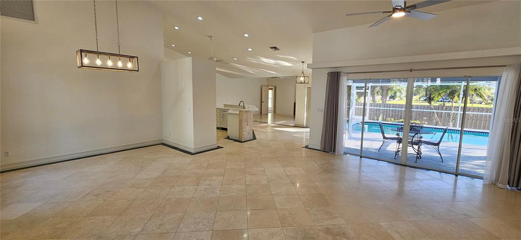 11729 Timberline Circle Fort Myers, FL 33966 - Photo 3 of 33 a view of a hallway with floor to ceiling window and wooden floor