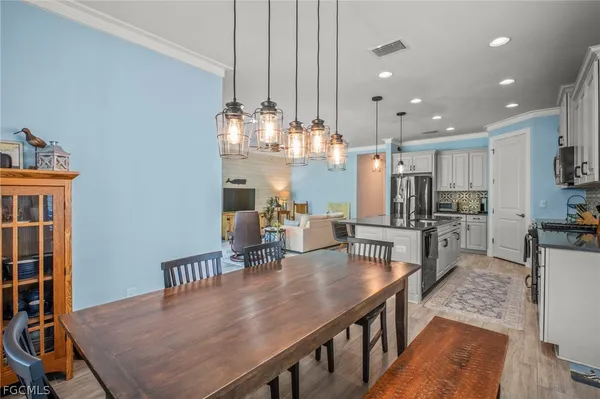 a kitchen with stainless steel appliances granite countertop a kitchen island a stove a table and chairs