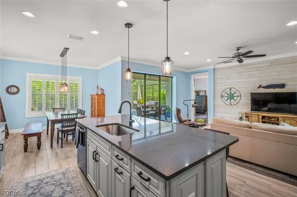 a kitchen with sink stove and chairs
