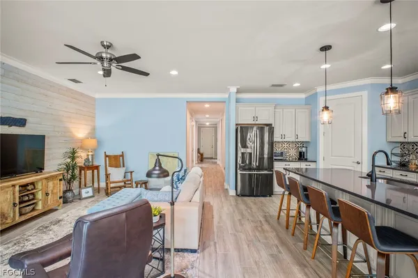 a view of a dining room and a kitchen with a table chairs
