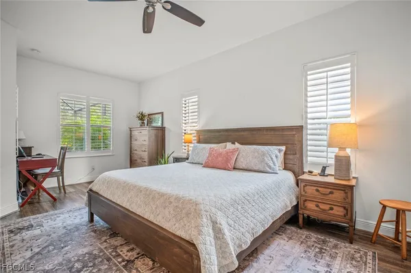 a bedroom with a bed a table and chair