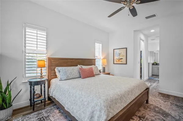 a bedroom with a large bed and a chandelier