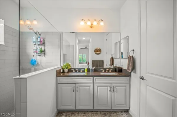a bathroom with a sink vanity and mirror