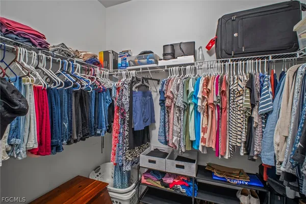 a view of walk in closet with clothes