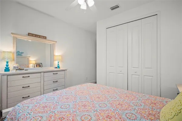 a bedroom with a bed and a dresser
