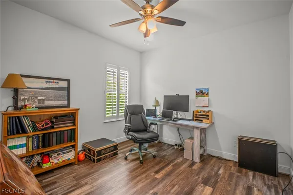 a view of a workspace with furniture and a window