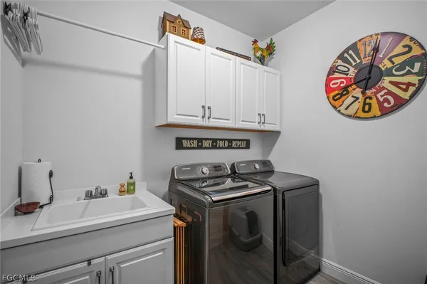 a view of kitchen with stove and cabinets