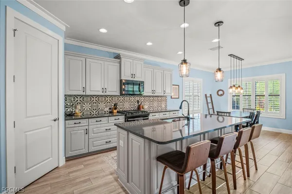 a kitchen with granite countertop sink cabinets and refrigerator