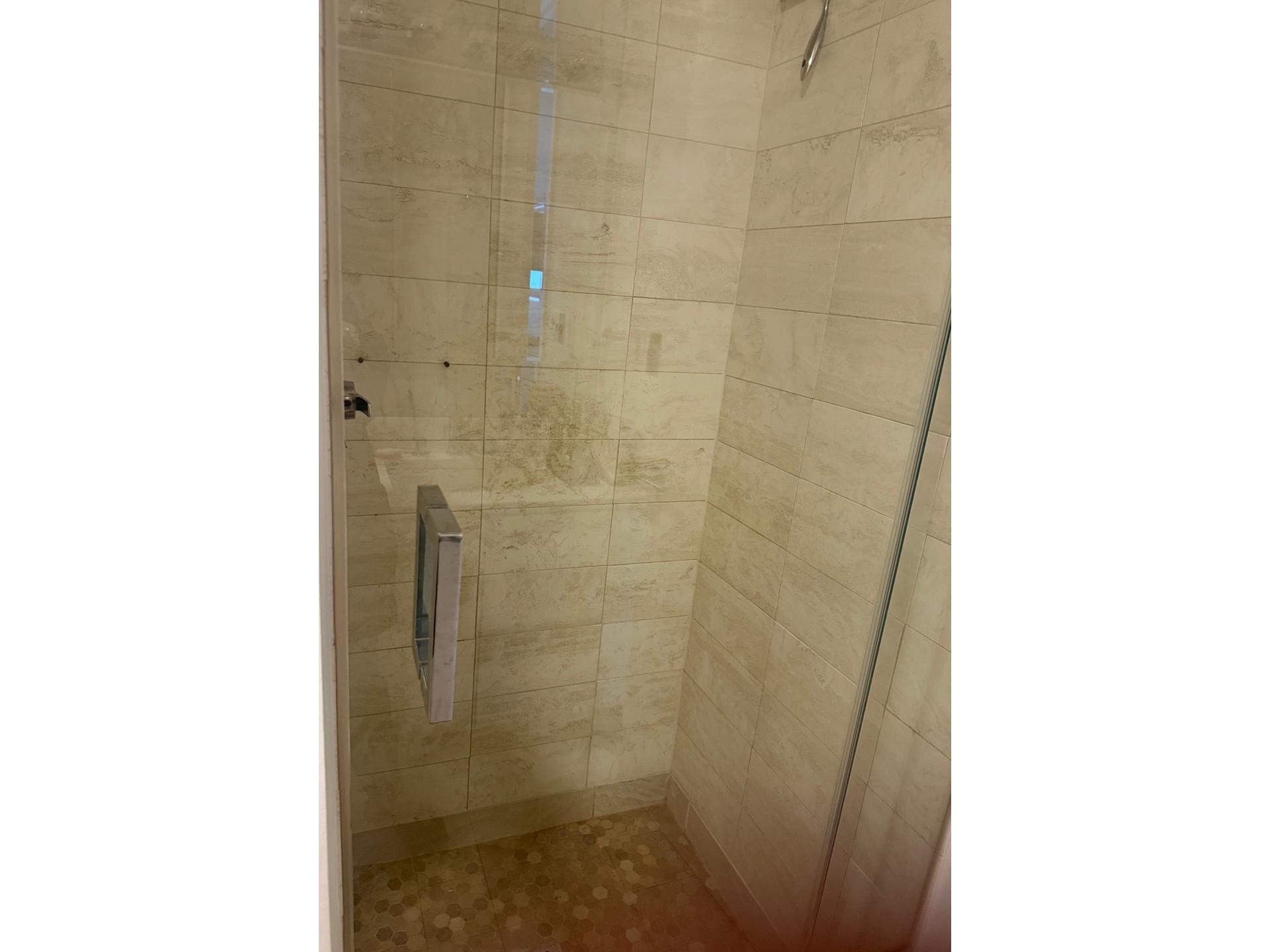 200 East 61st Street, Unit 14B Manhattan, NY 10065 - Photo 6 of 15 a bathroom with a shower