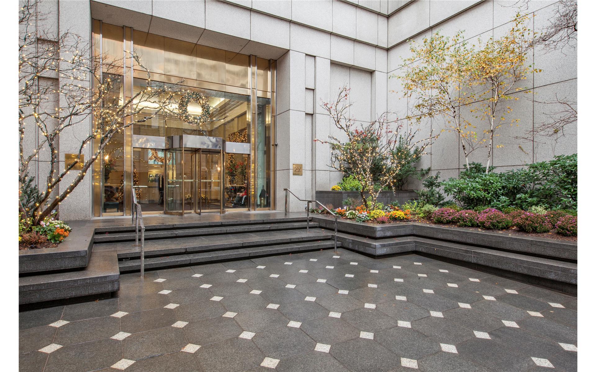 200 East 61st Street, Unit 14B Manhattan, NY 10065 - Photo 7 of 15 a outdoor space with lots of white furniture and shower