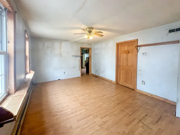 wooden floor in an empty room with a window