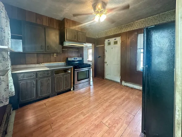 a kitchen with stainless steel appliances granite countertop a sink and cabinets