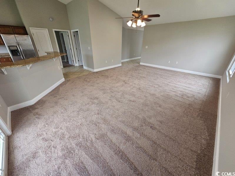 684 Rambler Court Myrtle Beach, SC 29588 - Photo 4 of 15 Unfurnished living room with light colored carpet, high vaulted ceiling, and ceiling fan