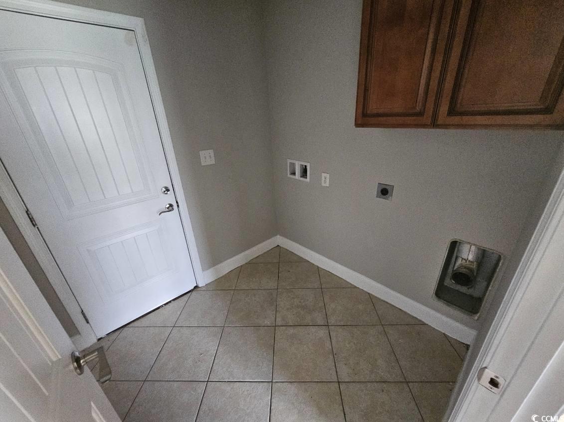 684 Rambler Court Myrtle Beach, SC 29588 - Photo 7 of 15 Laundry area with light tile patterned floors, hookup for a washing machine, electric dryer hookup, and cabinet space