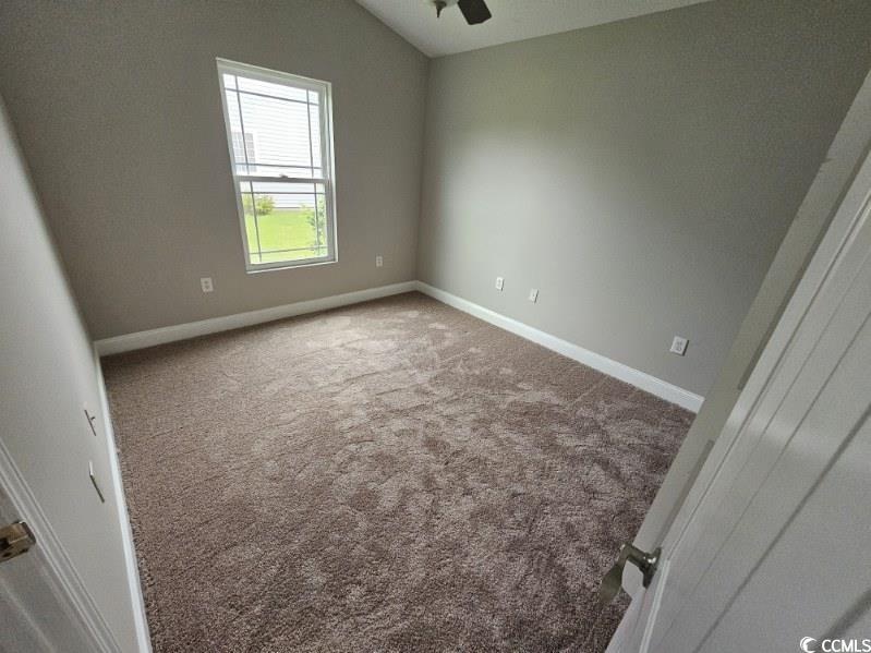 684 Rambler Court Myrtle Beach, SC 29588 - Photo 8 of 15 Spare room with carpet flooring and lofted ceiling