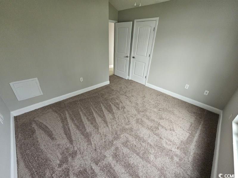 684 Rambler Court Myrtle Beach, SC 29588 - Photo 9 of 15 Unfurnished bedroom featuring carpet floors and a closet