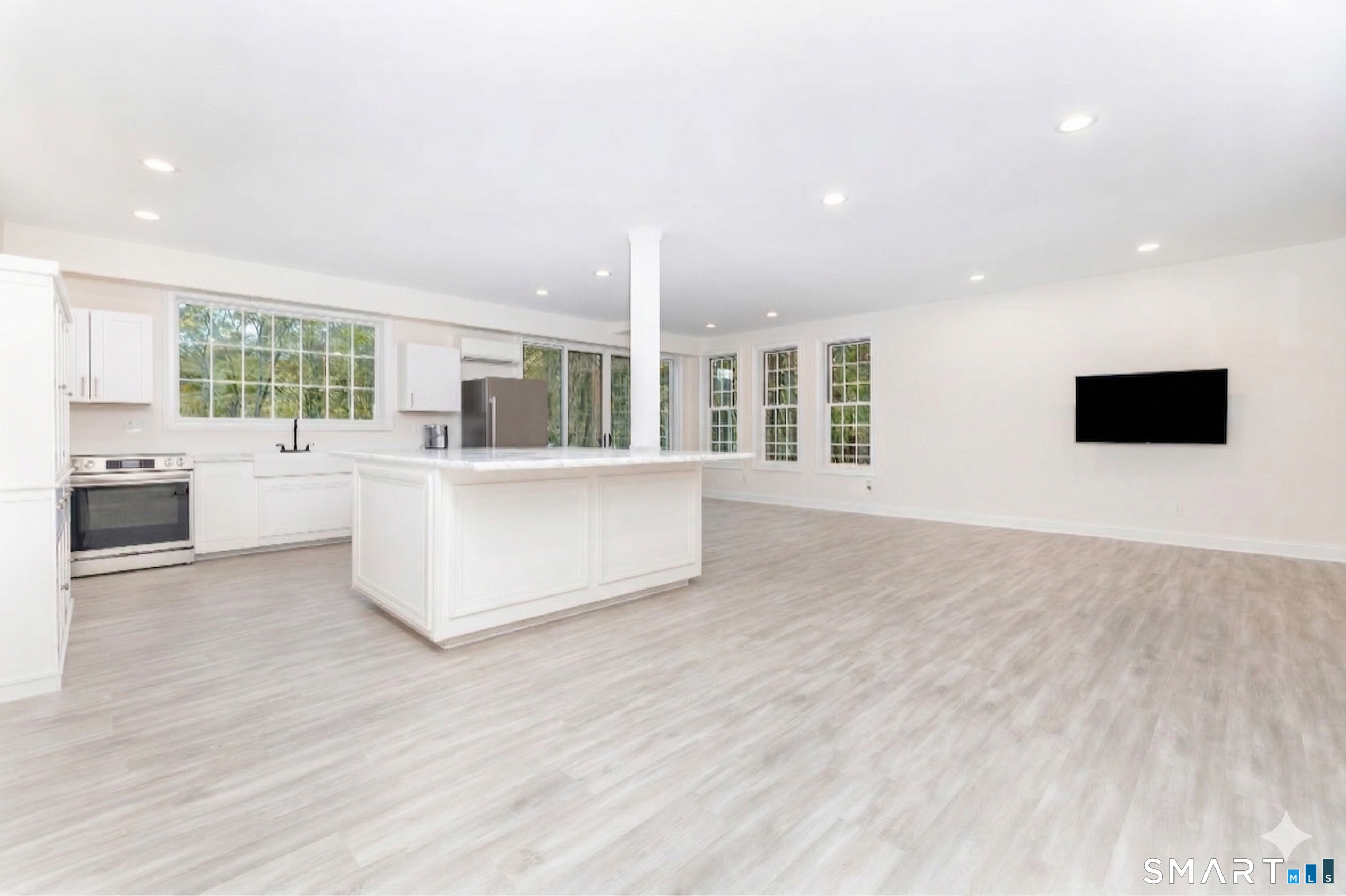 235 White Deer Rock Road, Unit GUEST Woodbury, CT 06798 - Photo 3 of 19 a large living room with stainless steel appliances kitchen island granite countertop a large kitchen counter top a stove and a sink