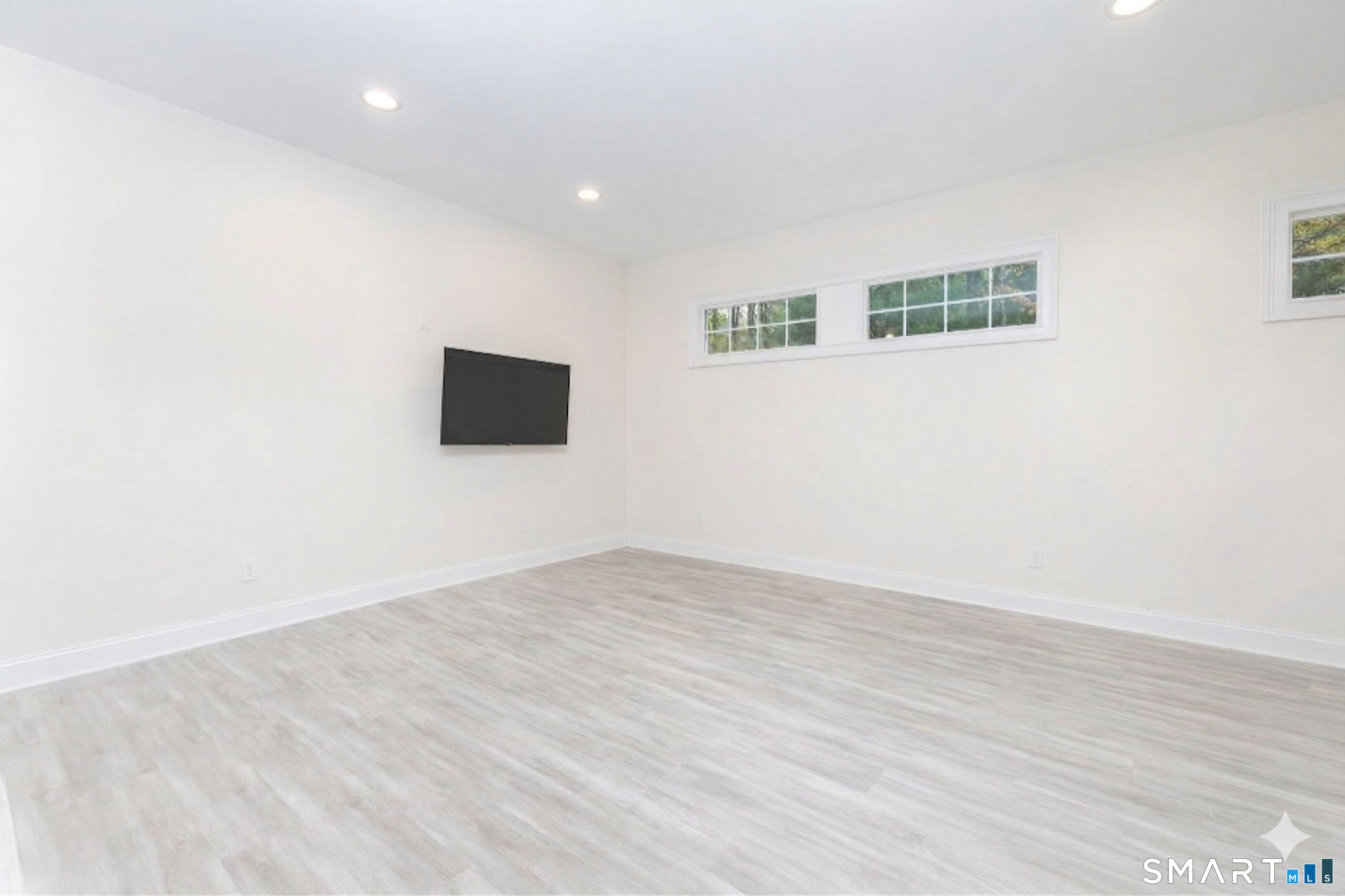 235 White Deer Rock Road, Unit GUEST Woodbury, CT 06798 - Photo 4 of 19 an empty room with wooden floor and windows