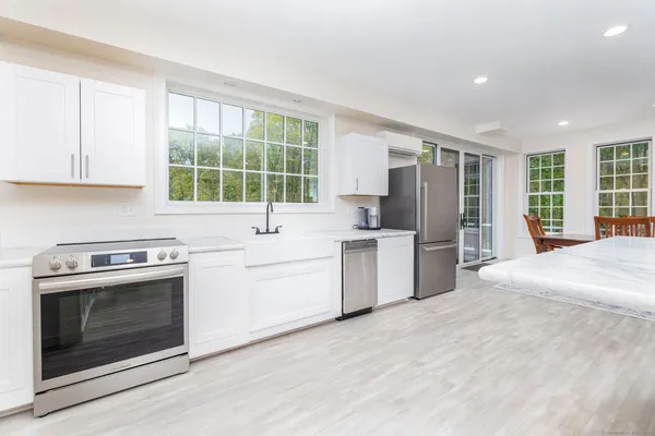 a kitchen with a stove a sink and a refrigerator