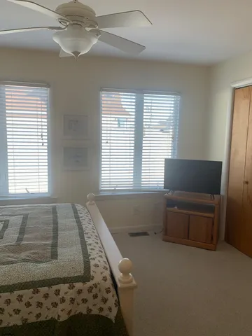 a spacious bedroom with a bed and a couch