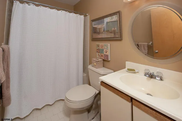 a bathroom with a sink mirror vanity and toilet