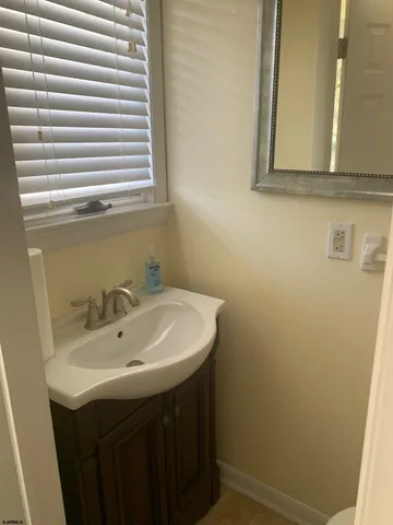 a bathroom with a sink and a window