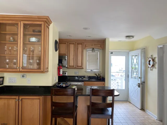 a kitchen with a sink cabinets and wooden floor