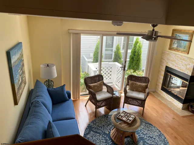 a living room with furniture fireplace and a large window