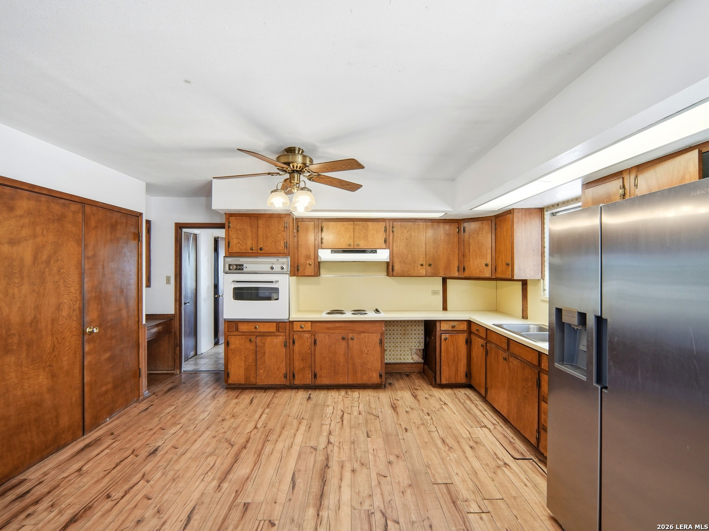 300 Ave M Hondo, TX 78861 - Photo 16 of 37 a large kitchen with kitchen island a large counter space wooden floor and stainless steel appliances